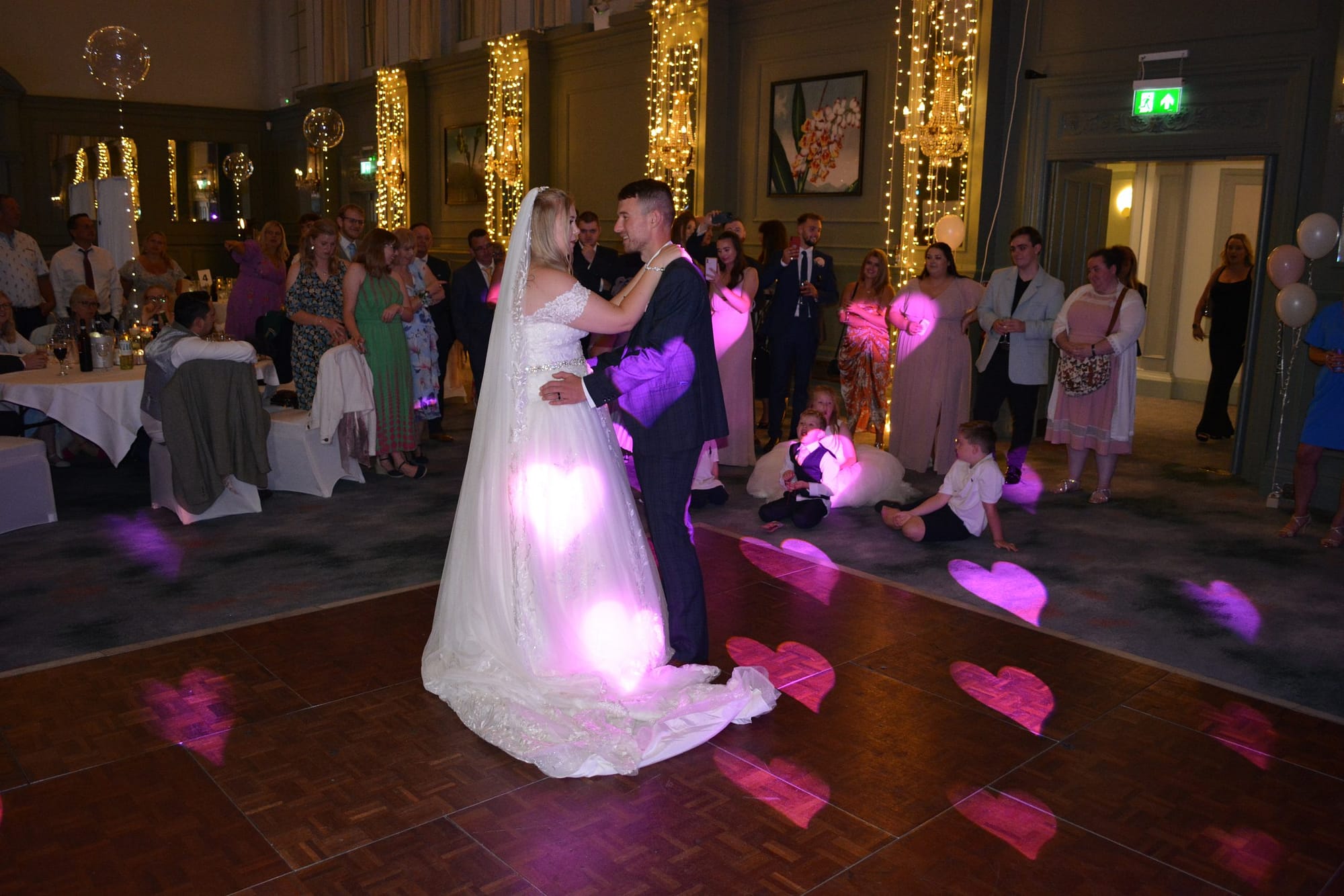 Wedding car and bride and groom